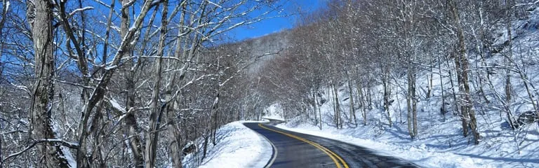 A mountain road winding through a winter forest near Mount Jefferson