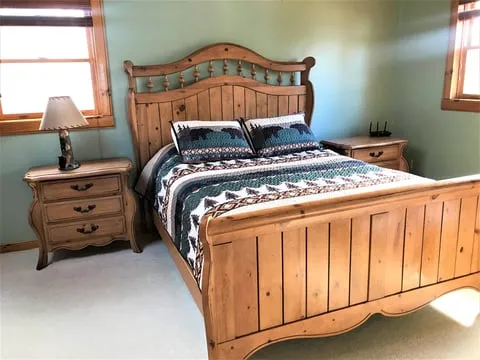 Queen bedroom with blue patterned bedding