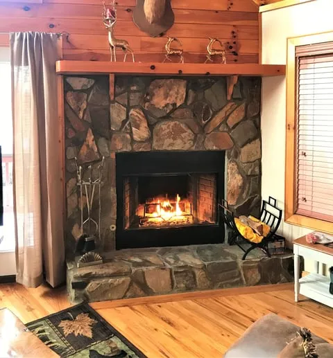 Stone fireplace with a glowing fire insert