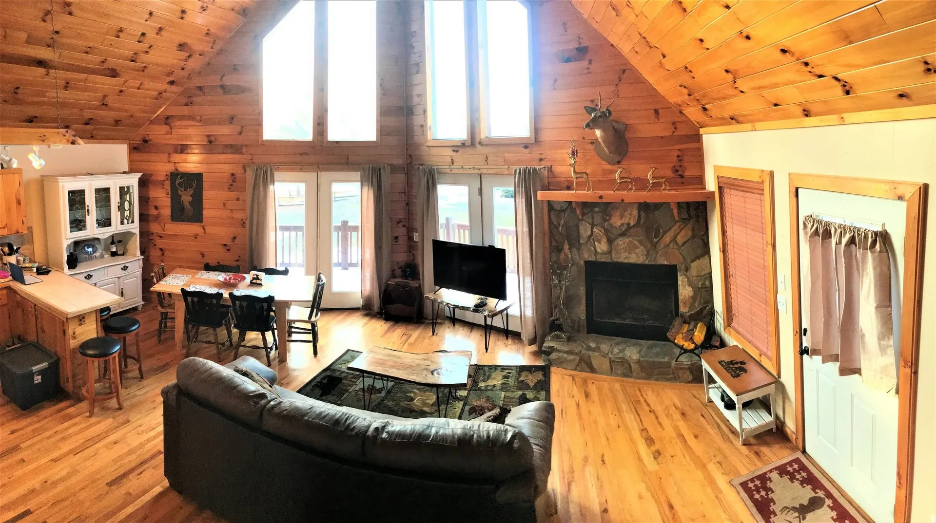 Open living room at Lazy Deer Cabin with tall windows and wood details